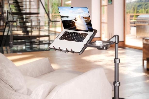 Adjustable LEVO G2 Deluxe Laptop Stand on wheels next to a sofa